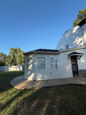 A single-story house with a garage, a small porch, and a well-maintained lawn.