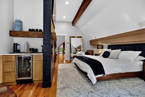 A bedroom with a large bed, a wooden headboard, and a built-in wardrobe. - Wintergreen Luxury! Sleeps 18 with Hot Tub, Sauna, Arcades (Wintergreen Resort)