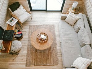 A cozy interior with a sofa, a coffee table, and a chair. - Tranquil Cabin Escape with Private Sauna & Kayak Fun in Mission Township, Minnesota (Mission Township)