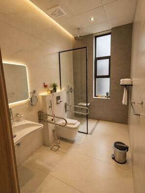 A modern bathroom with a glass-enclosed shower, a sink, and a toilet. - tamouh almuttahida hotels (madinah)