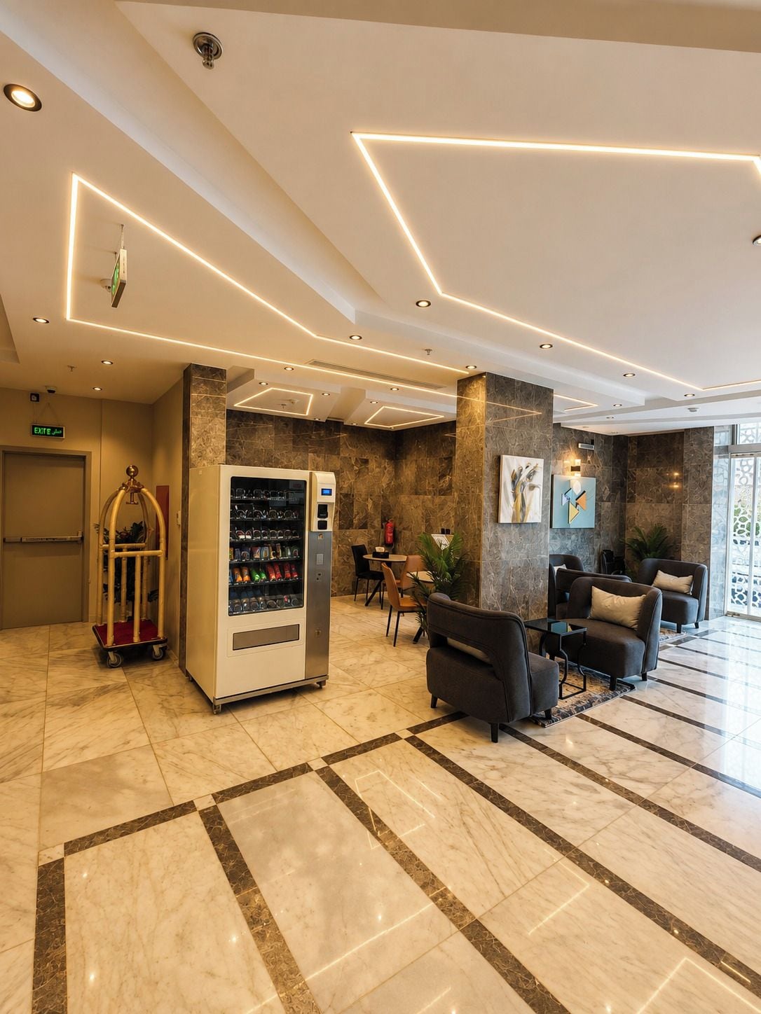 A modern lobby with a vending machine, seating area, and a marble floor.