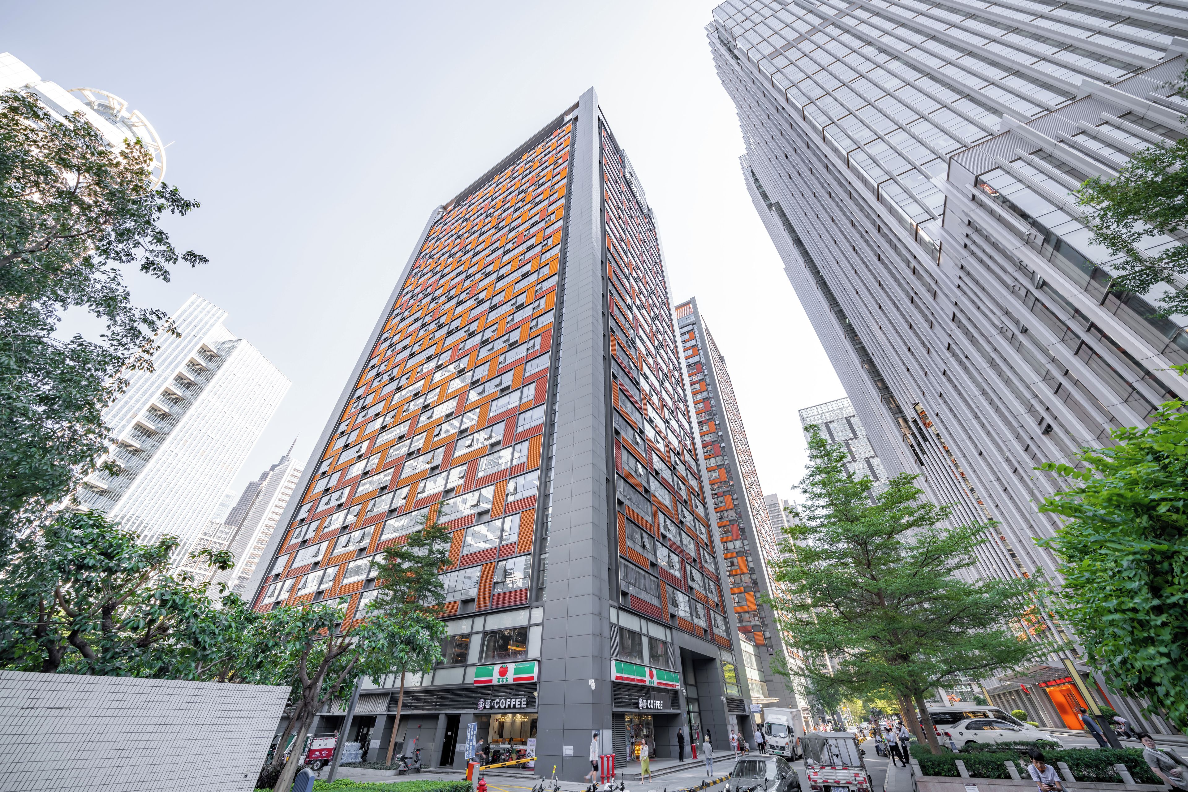 A high-rise building with a modern architectural design, featuring a mix of glass and metal facades.