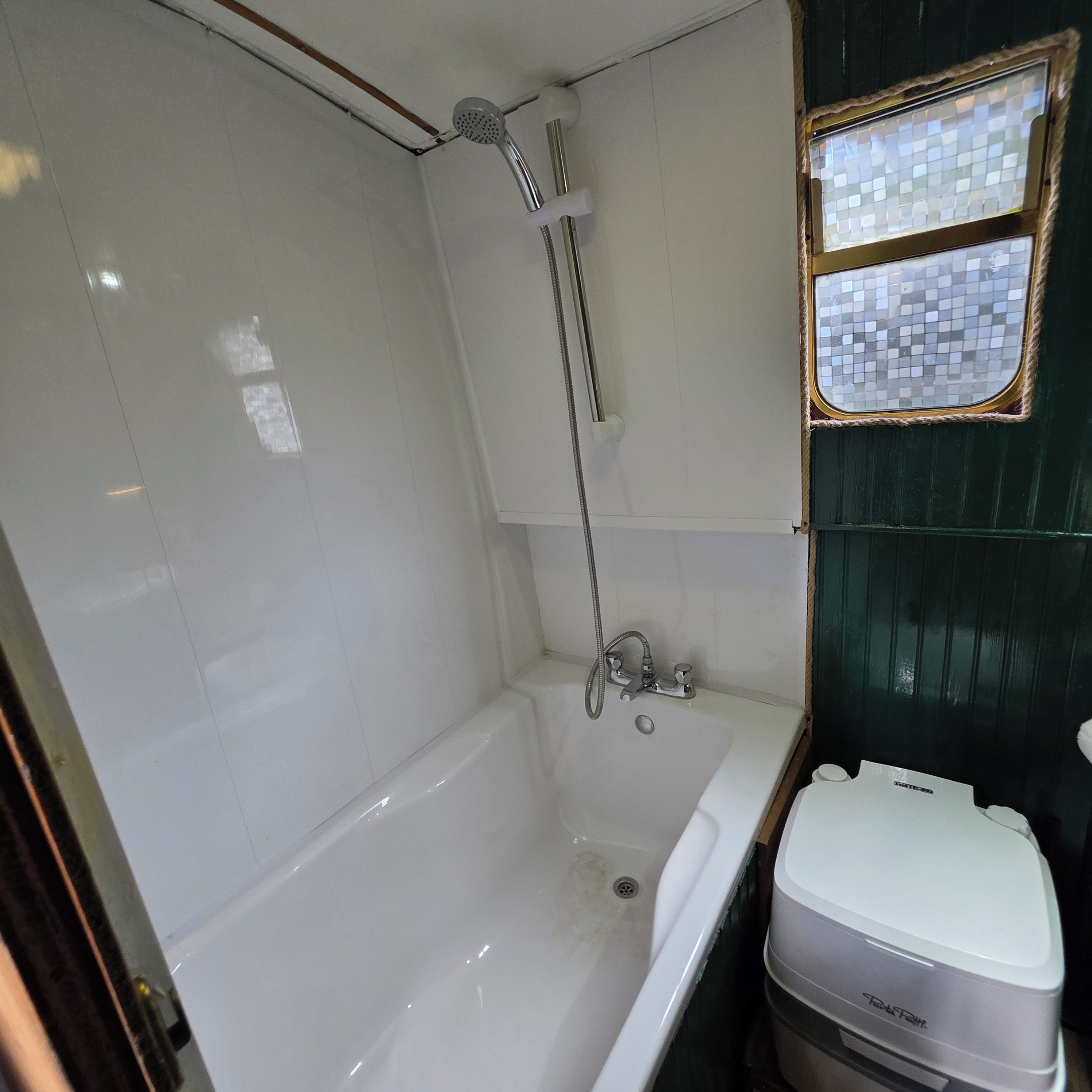 A bathroom with a bathtub, a shower, and a toilet.