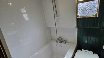 A bathroom with a bathtub, a shower, and a toilet.