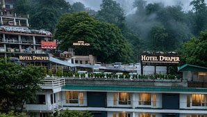 A multi-story hotel with balconies and a view of surrounding greenery. - Hotel Dwaper by Aventra Retreat  (Mussoorie)
