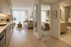 Un apartamento moderno con cocina, sala de estar y dormitorio.