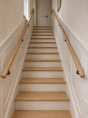 A staircase with wooden steps and white walls. - Charming Renovated Cape Cod Near Strong Hospital & U of R (Rochester)