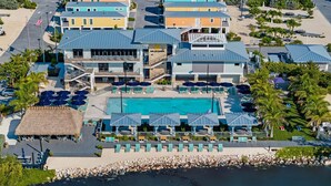 A resort with a swimming pool, multiple buildings, and a beachfront. - Tropic Paradise. New 2 bedroom 2 bath ocean front home in Islamorada (Islamorada)
