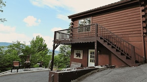 A two-story log cabin with a balcony and a staircase leading to the upper floor. - Sugardaddy's Cabin With Views And Fireplace (Sugar Mountain)
