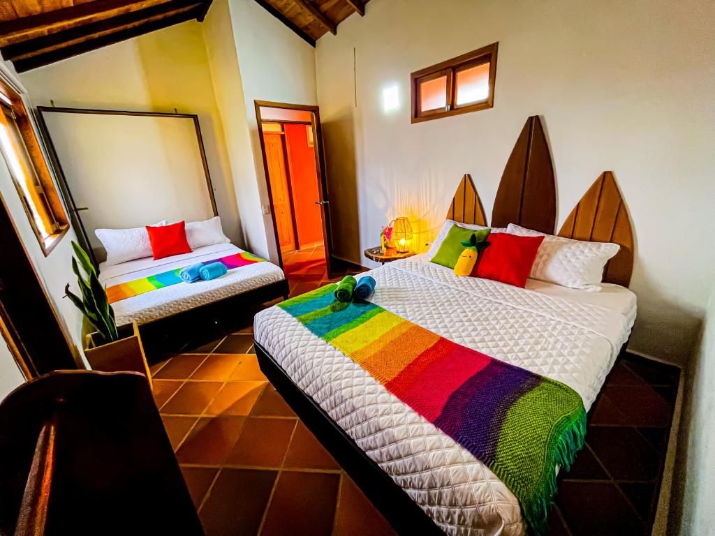 A hotel room with two beds, a nightstand, and a mirror.