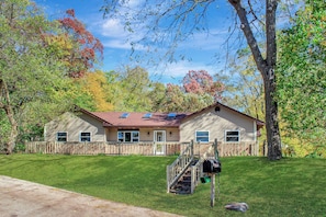 A single-story house with a front porch, a mailbox, and a small staircase leading to the front door. - Lake Front Getaway on Channel Lake (Antioch)