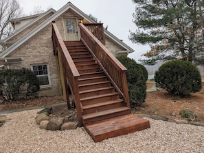 A two-story house with a wooden staircase leading to the front door. - Cozy Loft Retreat- Walk to Liberty Mountain Resort (Fairfield)