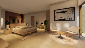 A modern bedroom with a large bed, bedside tables, a TV, and a painting on the wall. - Atlas Hostel Sri Lanka (Negombo)