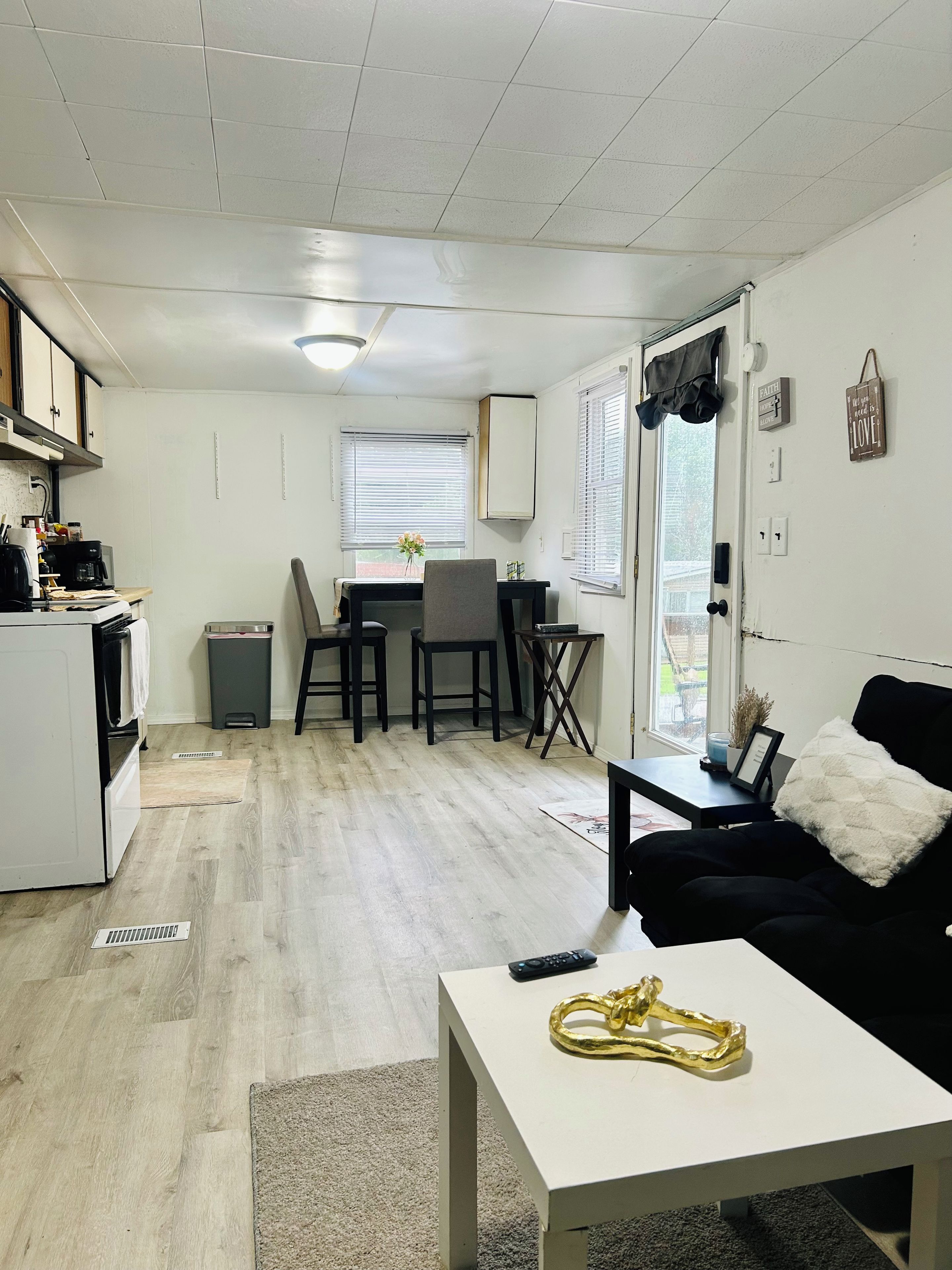 A compact living space with a kitchenette, dining area, and seating area.