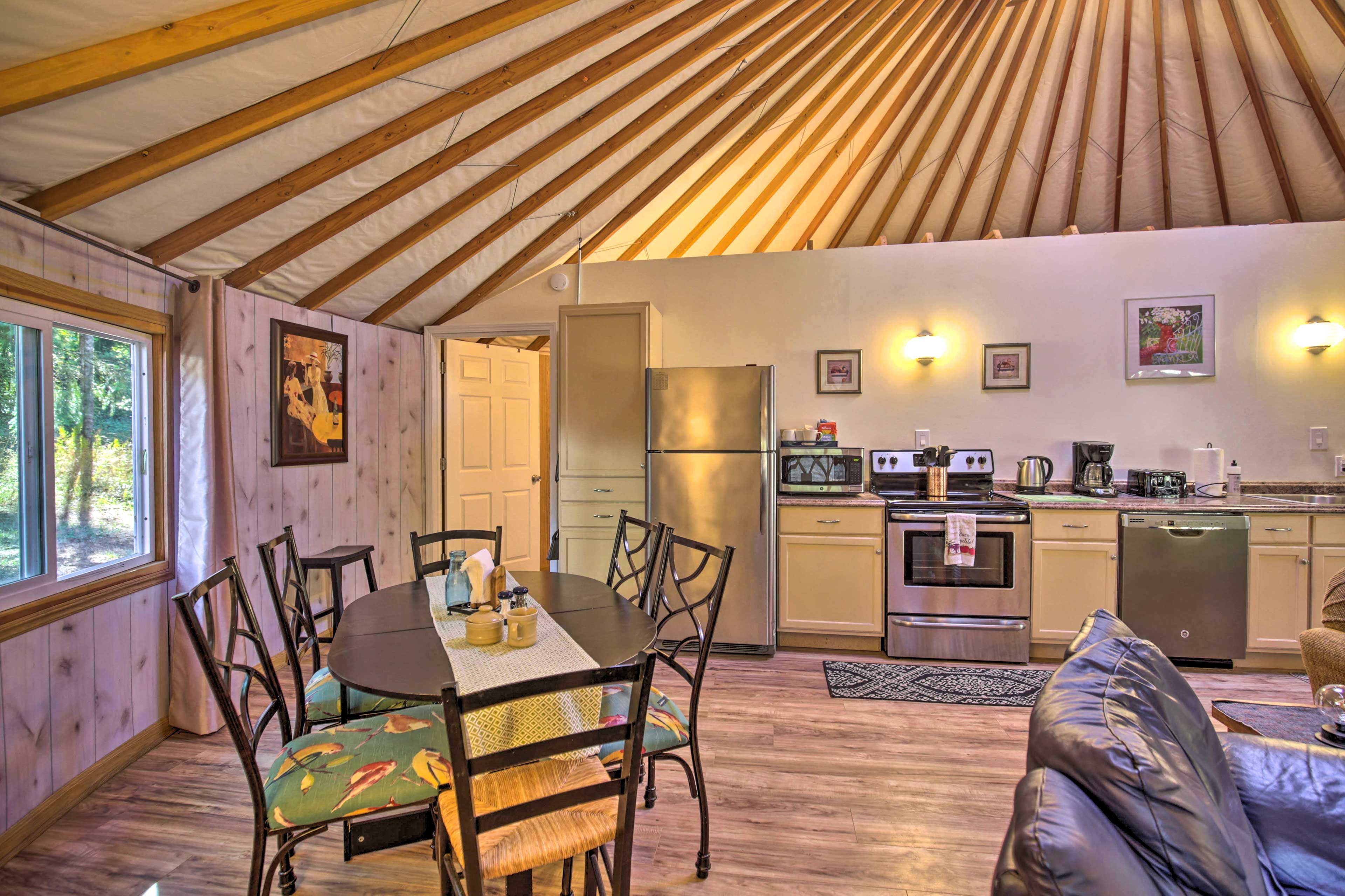 A cozy interior with a dining area, kitchen, and seating space.
