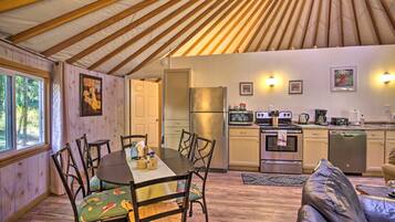 A cozy interior with a dining area, kitchen, and seating space.