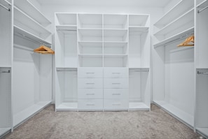 A walk-in closet with open shelving, drawers, and hanging space. - 5BR Bear's Den Estate Arcade, Pool & Game Room (Kissimmee)