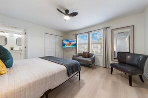 A bedroom with a bed, a chair, a sofa, a TV, and a ceiling fan. - 4BR Championsgate Themed Rooms & Private Pool (Davenport)