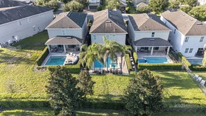 A residential area with multiple houses, each featuring a swimming pool and a patio area. - 6BR Encore w/ Under-the-sea Kids' Room & Pool (Kissimmee)