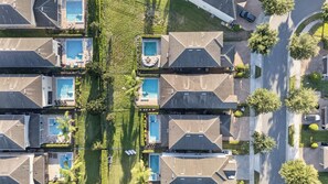 A residential area with multiple houses, each featuring a swimming pool and a well-maintained lawn. - 6BR Encore w/ Under-the-sea Kids' Room & Pool (Kissimmee)