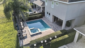 A residential property with a swimming pool, patio furniture, and a covered outdoor seating area. - 6BR Encore w/ Under-the-sea Kids' Room & Pool (Kissimmee)