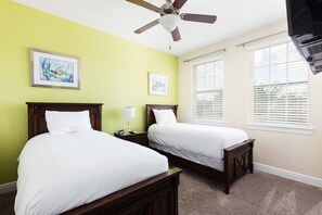 A hotel room with two beds, a ceiling fan, and artwork on the walls. - 9BR Encore Villa Pool, Spa & Water Park (Kissimmee)