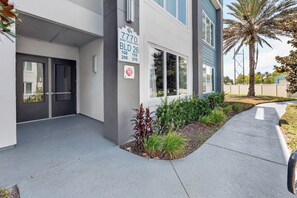 A building with a sign indicating '7770 Sandy Ridge Drive' and 'BLD 26'. - 5BR Reunion Resort Condo With Elevator and Share Pools (Kissimmee)