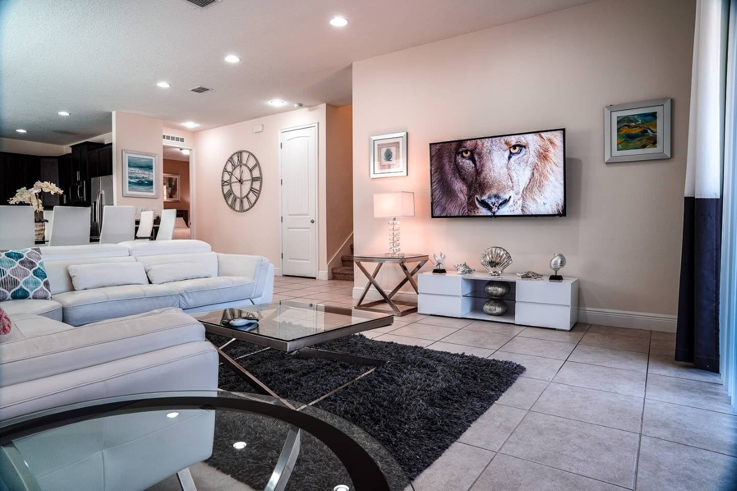 A modern living room with a sofa, coffee table, and decorative items.