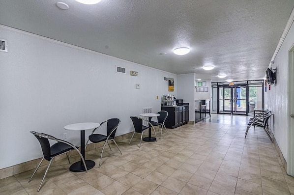 A clean, modern indoor space with a reception area, a counter, and seating arrangements.