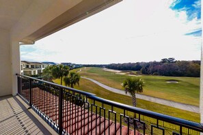 A balcony with a view of a golf course and residential buildings. - 6BR Reunion Mansion Circus Room & Karaoke (Kissimmee)