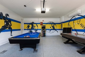 A room with a pool table, a billiards table, and walls decorated with sports-themed murals. - Encore 7BR Villa, Pool, Near Disney (Kissimmee)