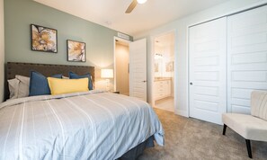A bedroom with a bed, a nightstand, a chair, and a closet. - 8BR Encore Villa With Galactic Game Room (Kissimmee)