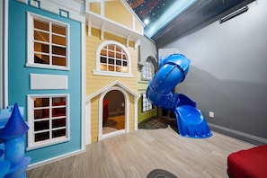 A children's play area with a slide and play structures. - Deluxe Mansion With Swim up Bar and Pool Slide at Reunion (Kissimmee)