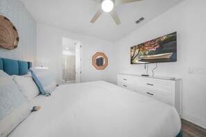 A bedroom with a bed, a dresser, a mirror, and a painting on the wall. - Bohemian Chic Villa With Themed Bedrooms at Reunion (Kissimmee)