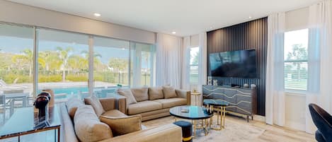 A modern living room with a sofa, coffee table, and TV.