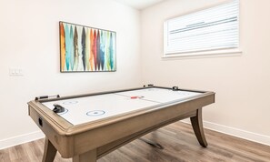 A room with a pool table, a window with blinds, and a colorful abstract painting on the wall. - Magical Villa With Themed Bedrooms at Reunion (Kissimmee)