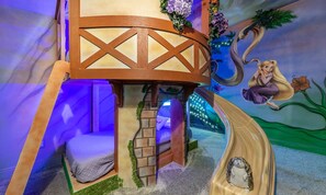 A children's play area with a treehouse, slide, and mural. - Magical Villa With Themed Bedrooms at Reunion (Kissimmee)