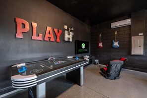 A room with a pool table, a mounted television displaying the Xbox One logo, and guitars on the wall. - Exquisite Home w/ Games Room at Encore (Kissimmee)
