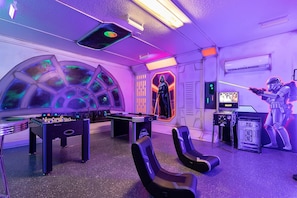 A room with a foosball table, gaming consoles, and Star Wars-themed decorations. - Relax at Encore: 8br, Pool, Minutes to Disney (Kissimmee)