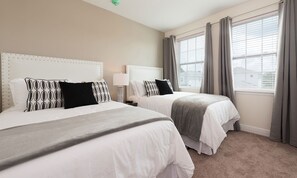 A hotel room with two beds, a window with curtains, and a lamp. - Stylish Sleek Home With Full Kitchen at Encore (Kissimmee)