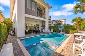 A modern two-story house with a swimming pool, outdoor seating, and a basketball hoop. - Modern Villa With Games Room at Reunion (Kissimmee)