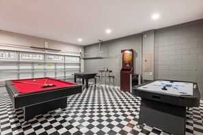 A room with a pool table, a foosball table, and a dartboard. - Spacious Home With South Facing Pool in Encore (Kissimmee)