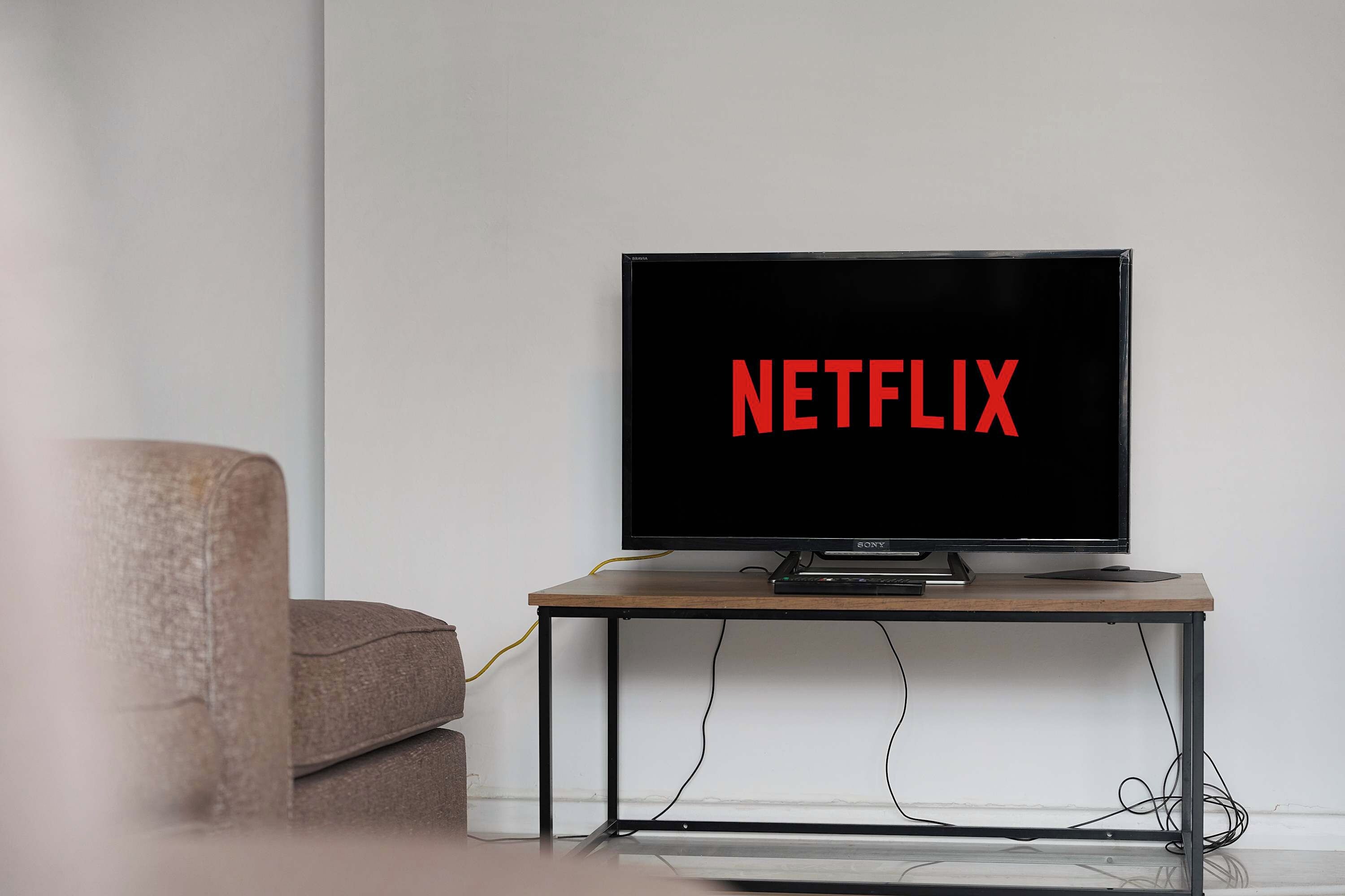 A television on a stand with the word 'NETFLIX' displayed on the screen.