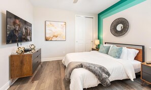 A bedroom with a bed, a dresser, a television, and artwork on the walls. - Marvelous Villa With Galactic Themed Bedroom at Encore (Kissimmee)