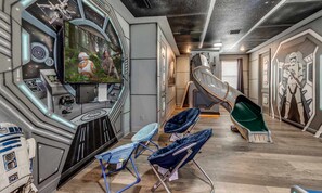 A room with a Star Wars theme, including a large screen, seating area, and wall decorations. - Marvelous Villa With Galactic Themed Bedroom at Encore (Kissimmee)