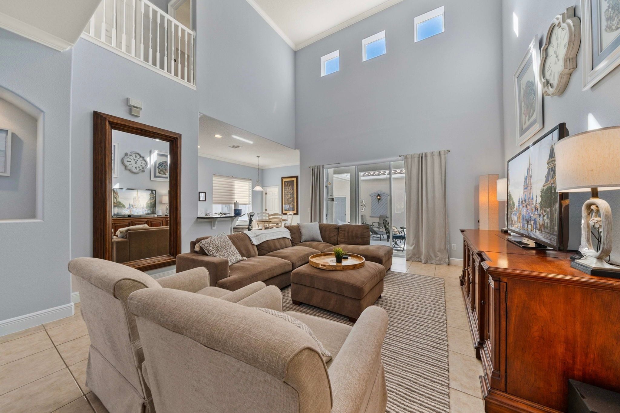 A spacious living room with a sectional sofa, a coffee table, and a television.