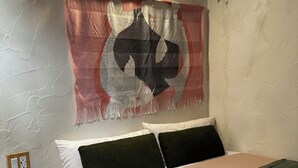 Ein Schlafzimmer mit einem Bett, Kissen, einer Wand-Klimaanlage und einer Steckdose.