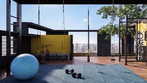 A modern gym with exercise equipment, a large exercise ball, and a bicycle. - Borde Vivo Santiago by Domus Travels (Santiago)