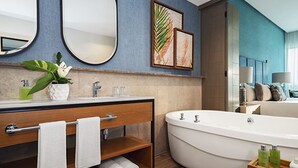 A modern bathroom with a freestanding bathtub, a vanity with a mirror, and a towel rack. - Exclusive Grand Mayan 1BR Suite w/ Plunge Pool Oct 26 - Nov 2 Confirmed (Nuevo Nayarit)