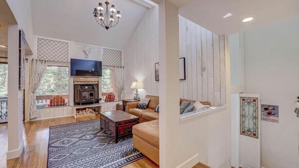 A cozy living room with a fireplace, a television, and a comfortable seating area. - Superb 4-bedroom condo with AC in quaint Brian Head steps from Giant Steps Lodge (Brian Head)